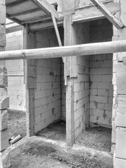 The view of the building of the resident's house in the middle of the rice field. Construction of building of concrete house.