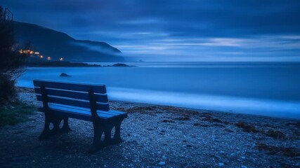 Bench overlooking ocean at dusk coastal landscape and scenic background