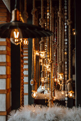 indoor area features hanging lights and ropes, creating warm and inviting festive atmosphere. soft lighting enhances rustic decor, perfect for late-night gatherings christmas. vertical. close up.