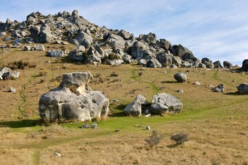 Vast fields dotted with large, unique limestone boulders characterize Castle Hill (Kura Tawhiti), Canterbury, New Zealand, in May 2025. This dramatic landscape reflects ancient geological forces. © Chonlatit