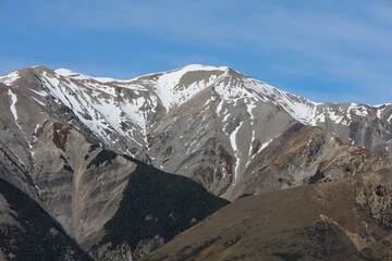 The striking, snow-capped mountains near Castle Hill (Kura Tawhiti), Canterbury, New Zealand, captured in May 2025. This close-up reveals rugged textures and clear skies over the unique landscape. © Chonlatit