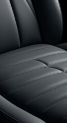 Fototapeta premium Detailed close-up of dark gray stitched leather seat upholstery.