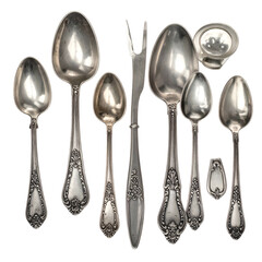 Ornate antique silver spoons and serving fork arranged on black.