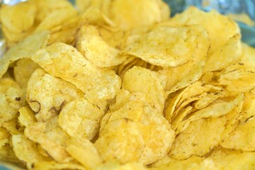 Close-up of crispy potato chips with golden texture and savory appeal
