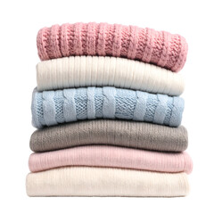 Stack of neatly folded knitted garments in soft pastel colors.