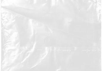 plastic transparent cellophane bag on white background. The texture looks blank and shiny. The plastic surface is wrinkly and tattered making abstract pattern