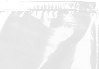 plastic transparent cellophane bag on white background. The texture looks blank and shiny. The plastic surface is wrinkly and tattered making abstract pattern