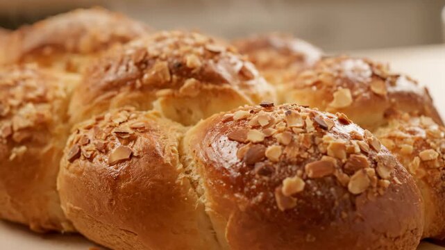 Freshly Baked Bread Rolls with Almond Topping - This video showcases a close-up of delicious, freshly baked bread rolls adorned with crunchy almond toppings.
