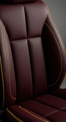 Obraz premium Luxurious burgundy leather seat with gold stitching detail.