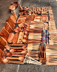 Handcrafted wooden kitchen utensils and bowls displayed at a Mexican artisan market