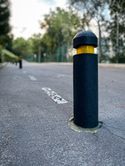 Urban bollard on an empty road with depth perspective