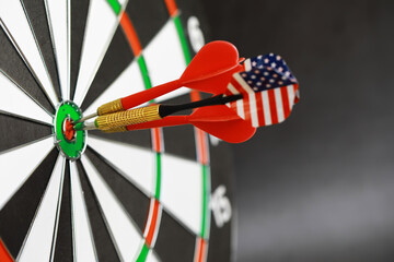 Close-Up of Darts with American Flag Design Hitting Bullseye on Target
