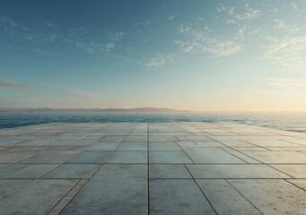 Fototapeta premium Empty paved platform overlooking a calm sea at sunset
