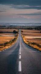 Empty road stretching into a golden sunset