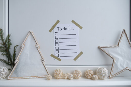 Paper note with inspirational TO DO CHECLIST with natural zero waste homemade Christmas decor. Happy new year promises resolutions concept. Self growth and personal development
