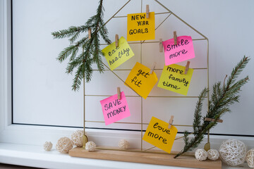 Vision board with new year resolutions aims goals on sticky notes. Preparation for New Year. Concept of planning and setting goals for personal development 