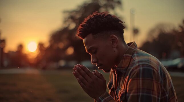 Reflection at Sunset: A young man, bathed in the warm glow of the setting sun, pauses in quiet contemplation, his hands clasped in a gesture of serenity, symbolizing introspection and peace. 