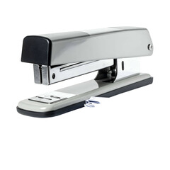 Office stapler fastens papers on a dark background.