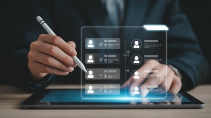 The person is holding a dark gray digital tablet horizontally with both hands, using a white stylus in their right hand to interact with it.