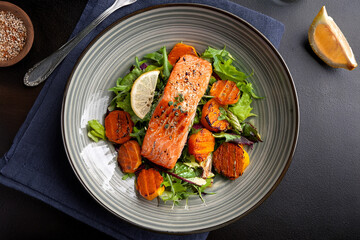 Balanced salmon salad with roasted vegetables promoting health awareness and food education
