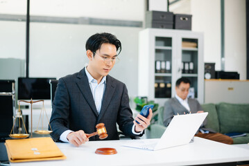 Asian business team and lawyers discussing contract papers sitting at the table. Concepts of law, advice, legal services.