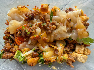 Rice noodle rolls are a colorful and appetizing street food in Thailand.