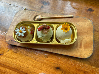Homemade ice cream decorated with edible flowers is beautiful and delicious.