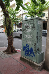 An electrical control panel was vandalized with graffiti on the roadside in Bangkok, Thailand.