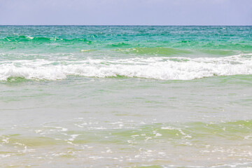 Waves turquoise blue water and sand at tropical beach Thailand.