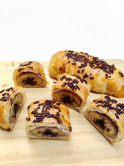 Gourmet Photography of Bolen Pisang Showing Flaky Texture and Sweet Filling