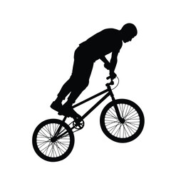Fototapeta premium Dynamic silhouette of a bmx rider performing a wheelie stunt against a silhouette