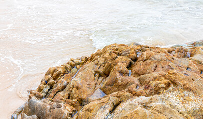 Amazing beach with rocks waves turquoise water in Patong Thailand.