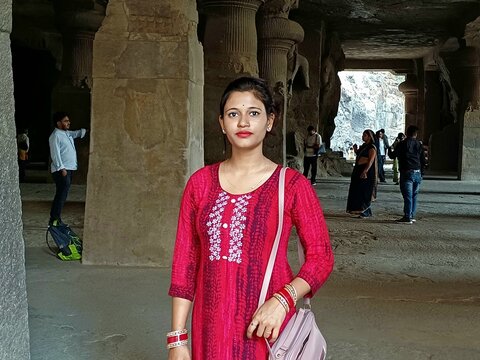 A young woman in traditional clothing in the Elephanta Caves, Mumbai.