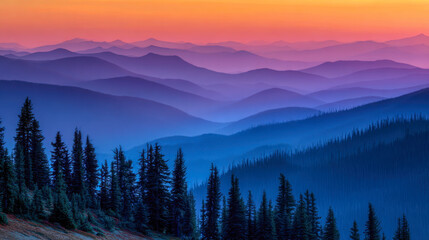 Obraz premium Layers of misty mountain ridges fading into a colorful sunset sky with silhouetted pine trees in the foreground creating a peaceful natural landscape scene