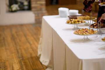 Elegant catered buffet table laden with a delightful assortment of sweet pastries and savory appetizers ready for guests to enjoy at a sophisticated event
