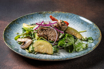 Warm beef salad with avocado and mushrooms