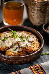 Traditional potato pancakes with mushroom sauce and herbs
