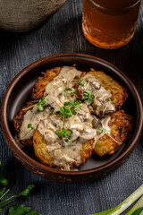 Crispy potato pancakes with creamy mushroom sauce