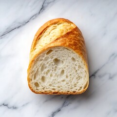 Freshly baked bread loaf on a marble surface isolated on white background