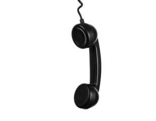 Retro black telephone receiver hanging by its cord against a stark black background