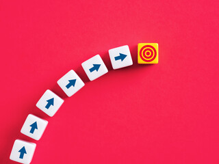 Arrows pointing to target on colorful blocks representing achieving business goals