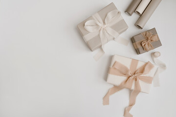 Christmas, New Year composition. Handmade winter holidays gift boxes with bows and ribbons. Festive packaging concept. Flat lay, top view