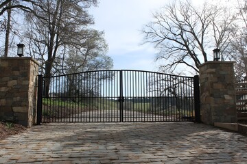 Estate Entrance with Dual Swing Gates Featuring Elegant Design and Grand Property Access