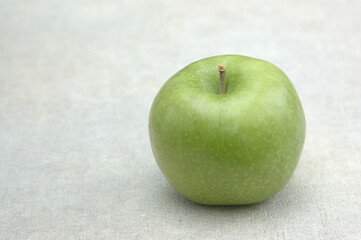 green apple on a wooden table