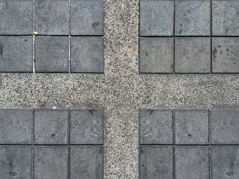 Close up of black stone tiles with cemented roughcast or pebbledash, good for car port flooring or outdoor garden floors. Seamless background texture