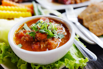 Delicious spicy northern Thai pork and tomato in white bowl. Traditional of Thai food