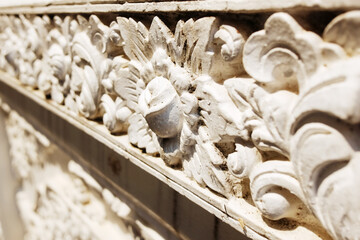 Details of the floral stucco carvings in the ancient temple exterior in Thailand