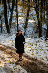 Girl walking forest path during winter snowfall