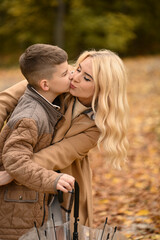mother and son playing in the autumn park