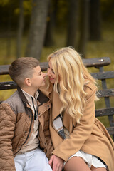 Fototapeta premium mother and son playing in the autumn park